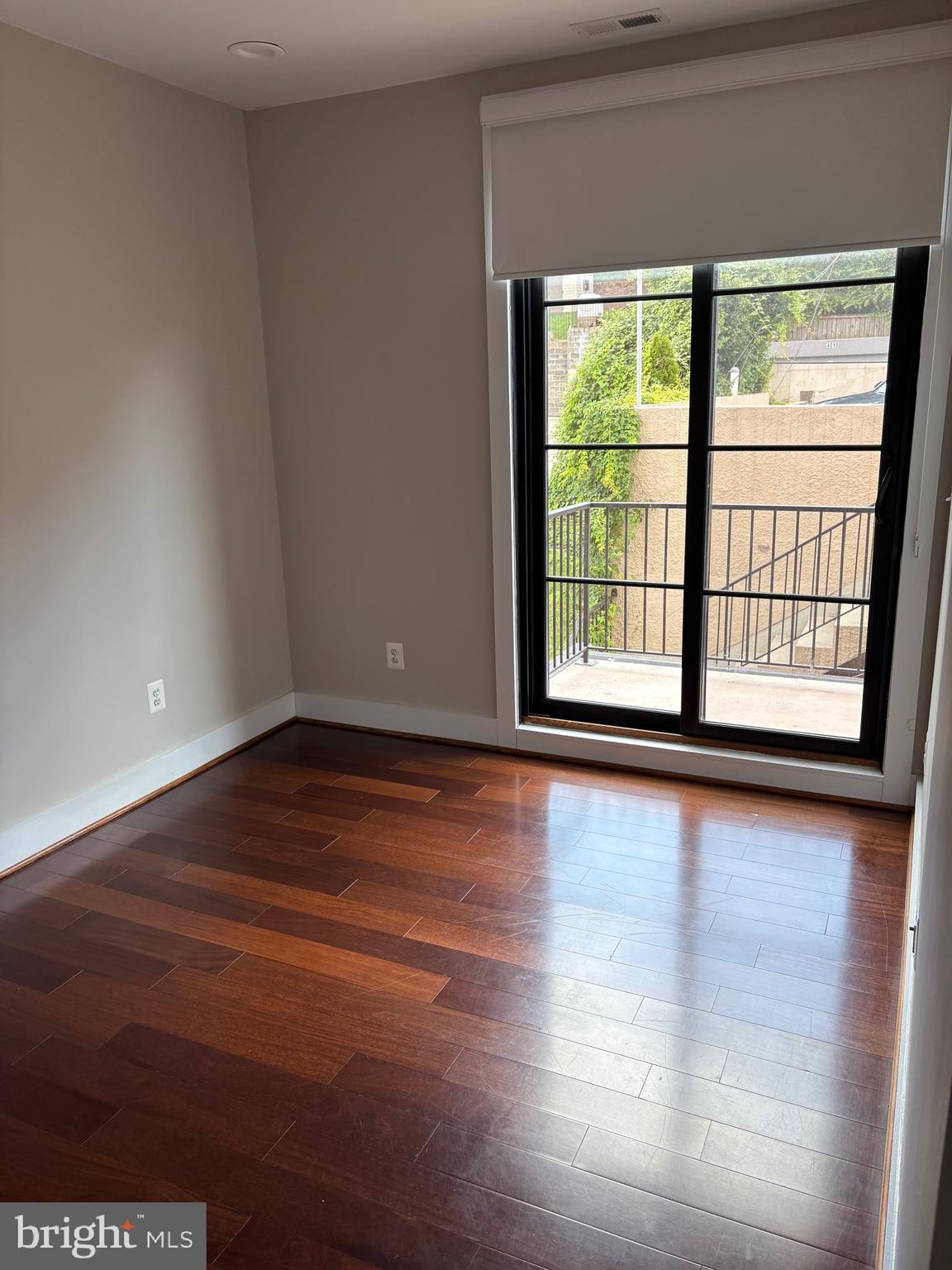 4004 Edmunds Street Northwest, Unit 7 Washington, DC 20007 - Photo 10 of 12 a view of a livingroom with wooden floor and a window