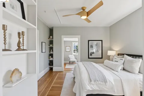 a bedroom with a bed and a painting on the wall