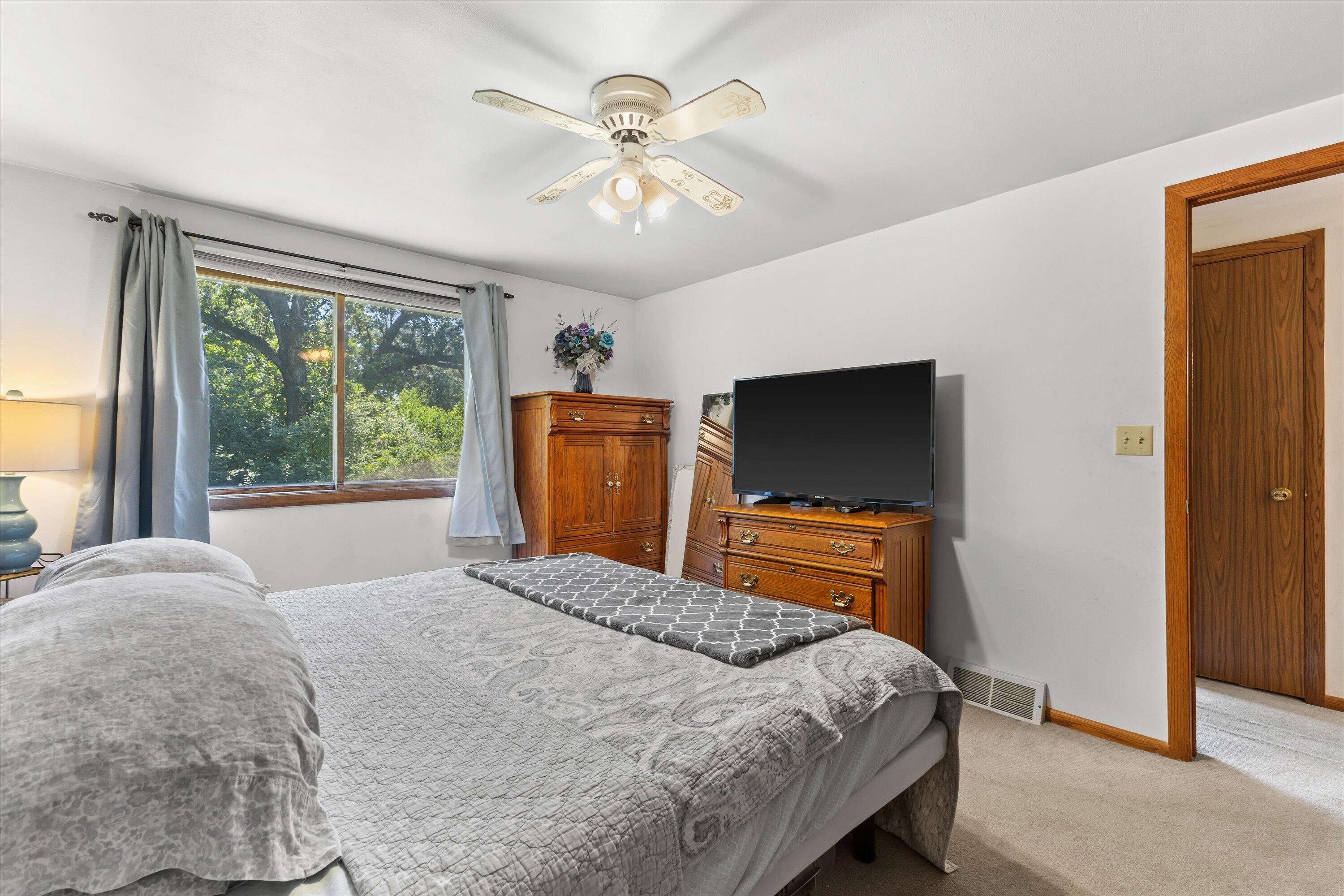 W347S7680 Sprague Road Eagle, WI 53119 - Photo 25 of 45 Primary Bedroom With Ceiling Fan & Plenty Of Natural Light