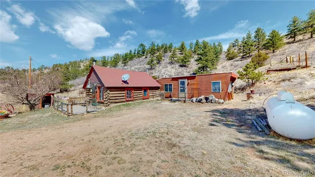 a view of a house with backyard and sitting area