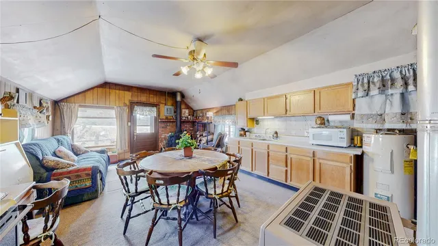 a kitchen that has a table and chairs in it