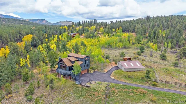 an aerial view of a house with outdoor space tennis court