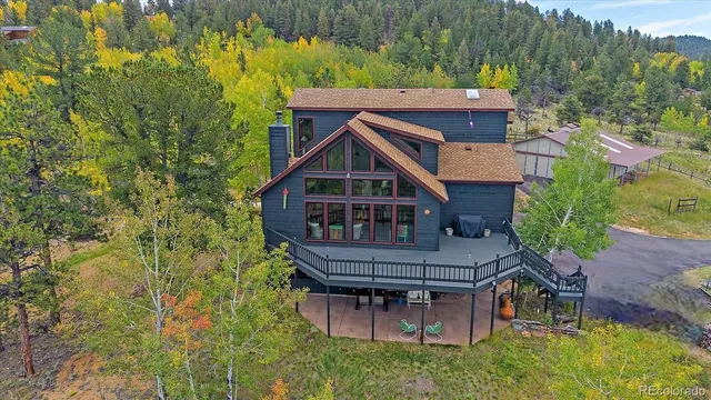 an aerial view of a house with a big yard