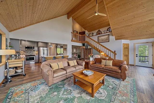 a living room with furniture ceiling fan and a rug