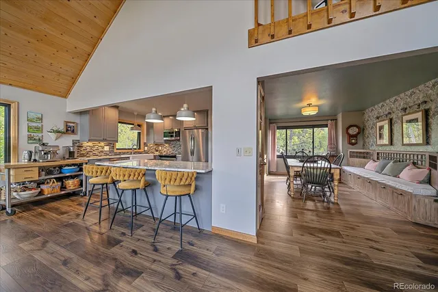 a dining room with furniture and wooden floor