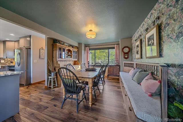 a dining room with furniture a rug and wooden floor