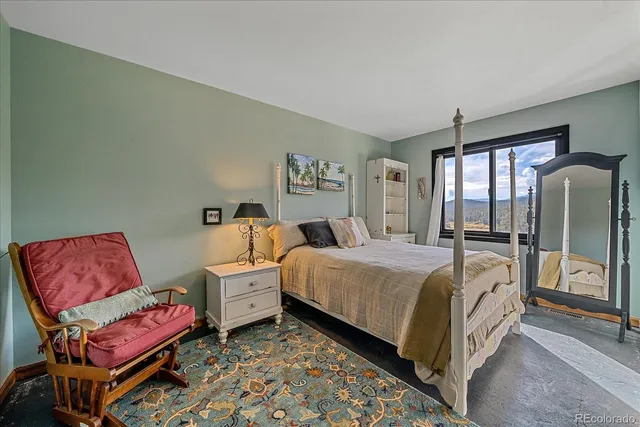 a spacious bedroom with a bed and a couch