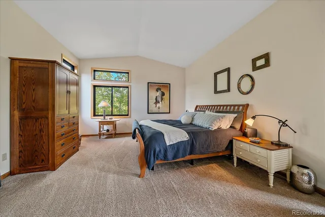 a spacious bedroom with a bed and a window