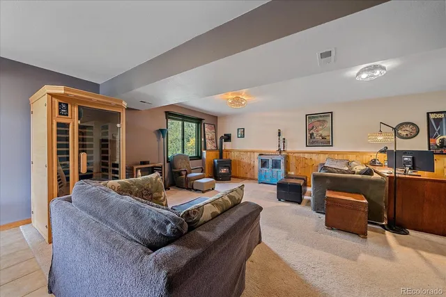 a living room with furniture kitchen view and a large window