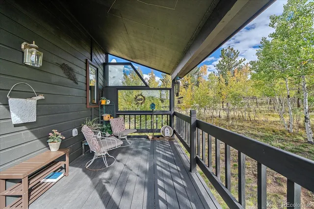 a view of a chairs and table in patio with wooden floor