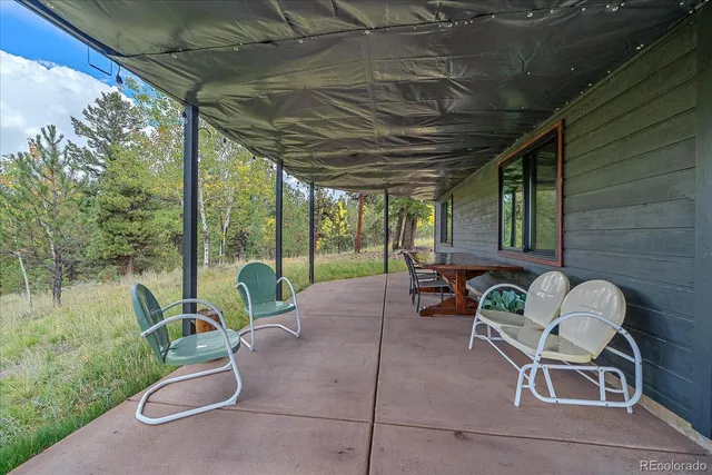 a backyard of a house with table and chairs