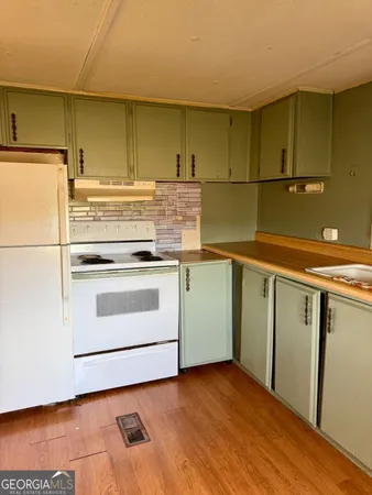 a kitchen with a stove and a refrigerator