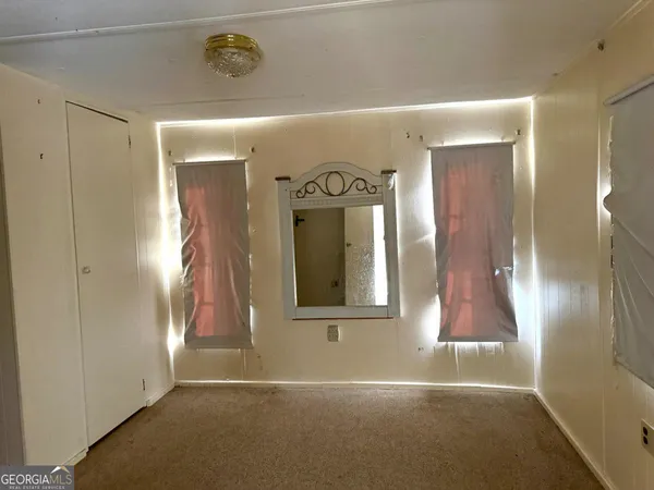 a view of a hallway of a room with a door