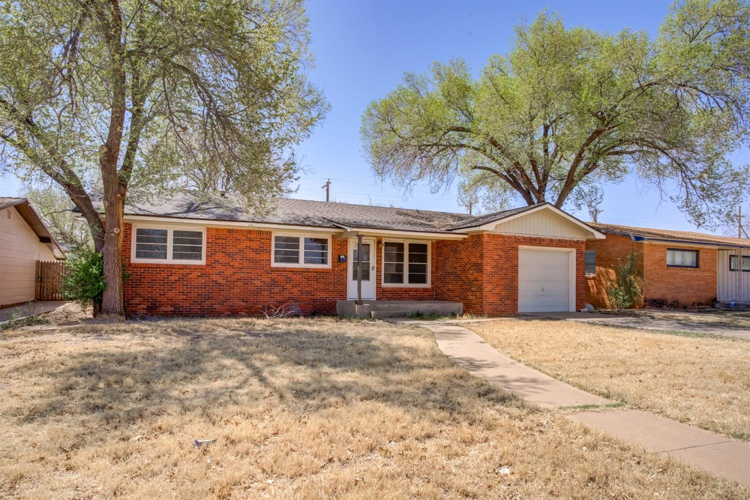 3011 44th Street Lubbock, TX 79413 - Photo 2 of 19 a front view of a house with a yard
