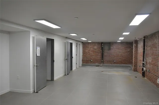 a view of a hallway with a room and a bathroom