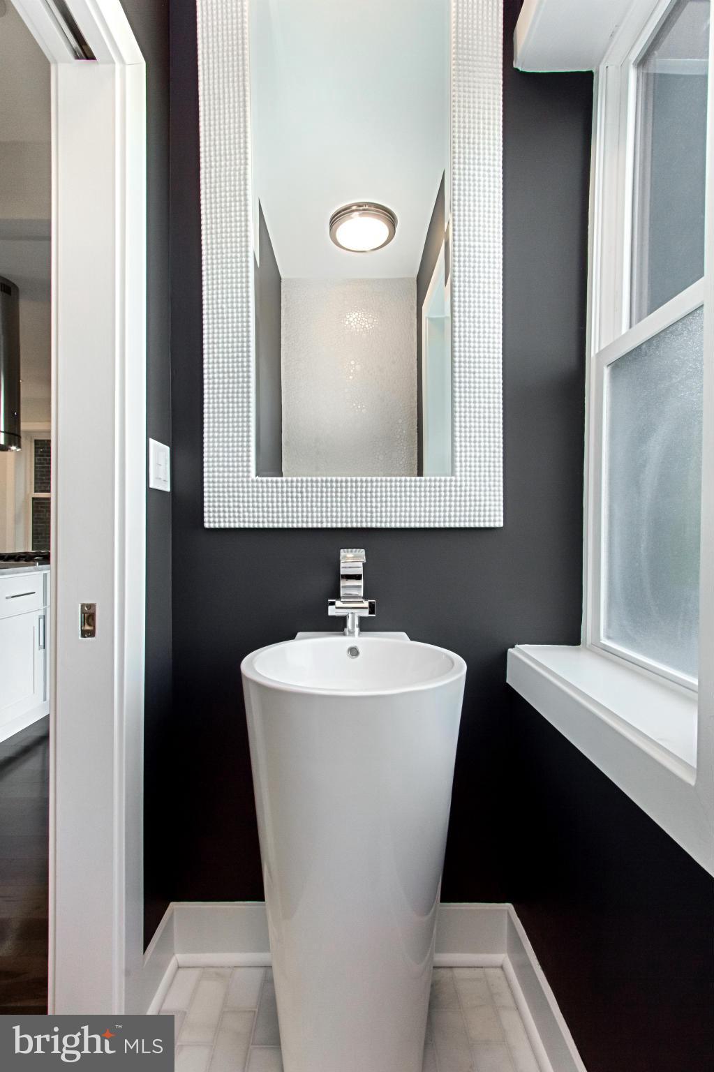 7533 12th Street Northwest Washington, DC 20012 - Photo 11 of 30 a bathroom with a sink mirror and toilet