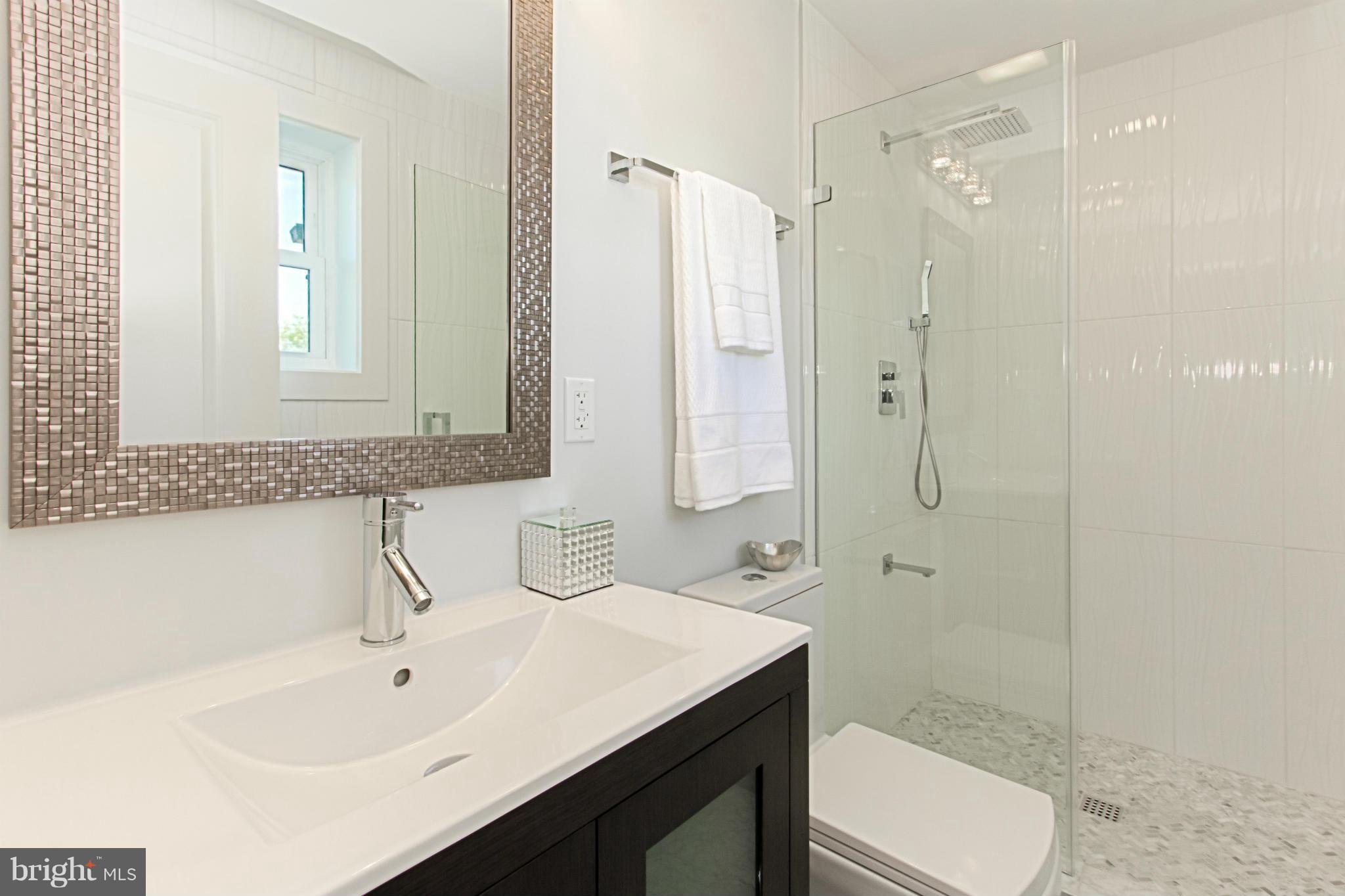 7533 12th Street Northwest Washington, DC 20012 - Photo 16 of 30 a bathroom with a sink a toilet and shower