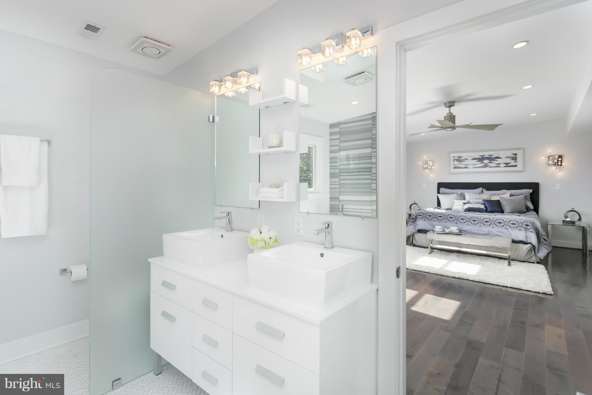7533 12th Street Northwest Washington, DC 20012 - Photo 21 of 30 a bathroom with a sink a large mirror and a shower