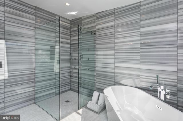 a bathroom with a bathtub and shower