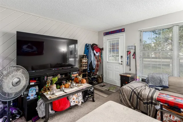 a bedroom with furniture and a flat screen tv