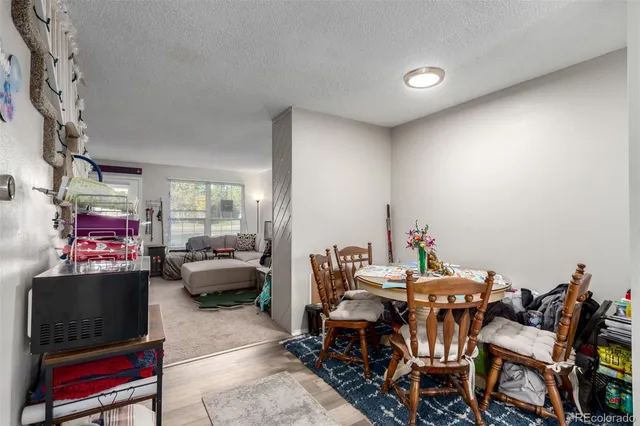 a dining room with a wooden table and chairs