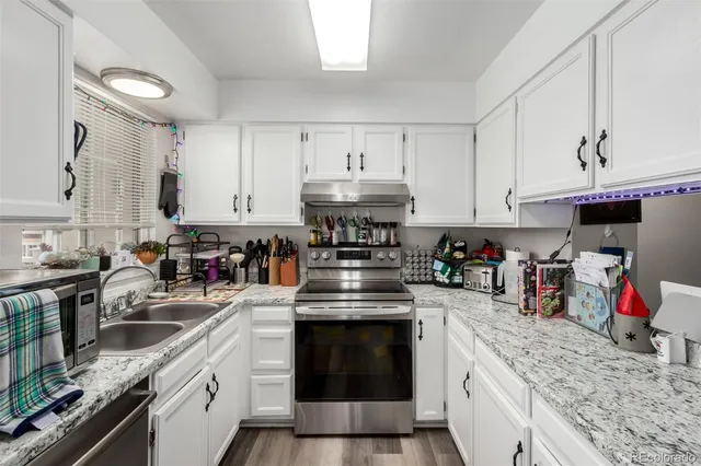 a kitchen with stainless steel appliances granite countertop a stove and cabinets