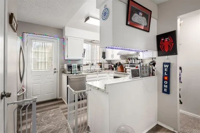 a kitchen with stainless steel appliances a refrigerator and a stove top oven