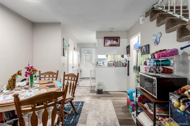a living room with furniture and a dining room