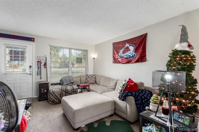 a living room with furniture a lamp and a window