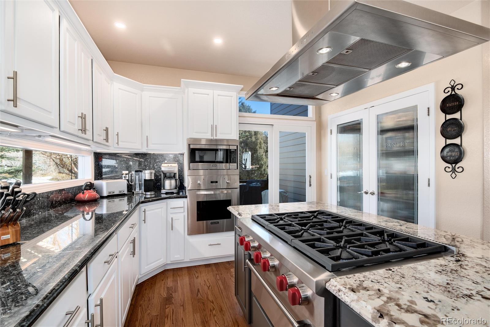 81 North Ranch Road Littleton, CO 80127 - Photo 11 of 38 a kitchen with stainless steel appliances granite countertop a stove and a refrigerator