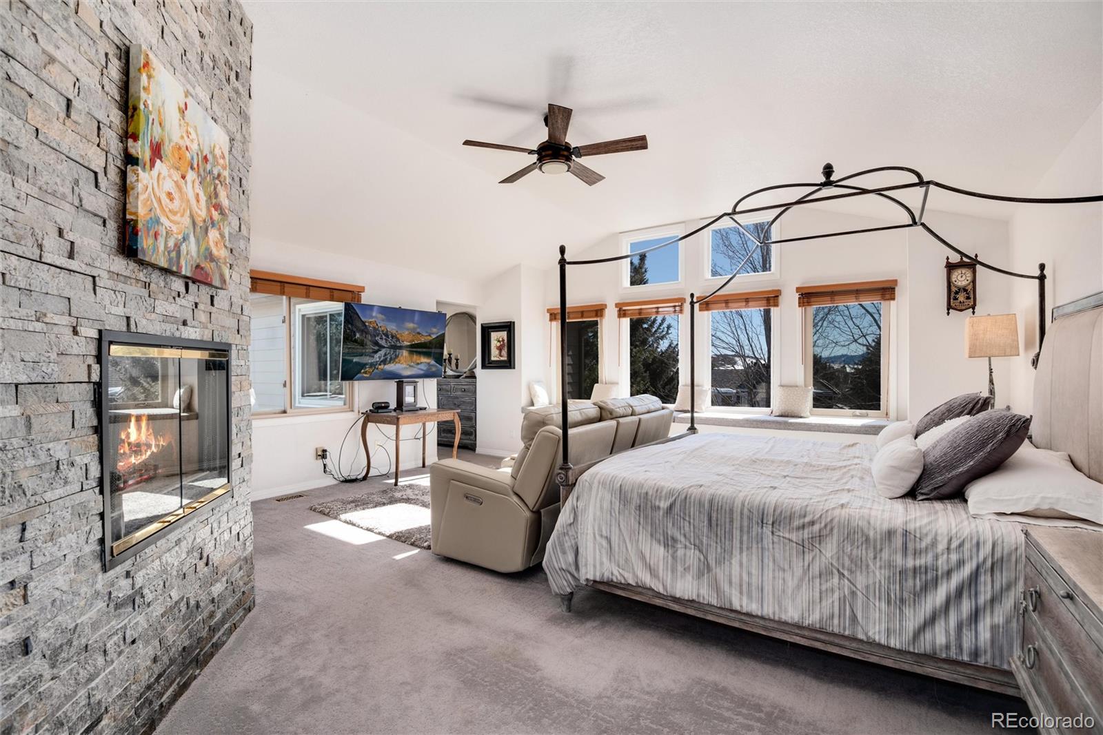 81 North Ranch Road Littleton, CO 80127 - Photo 16 of 38 a bedroom with a large bed and a chandelier