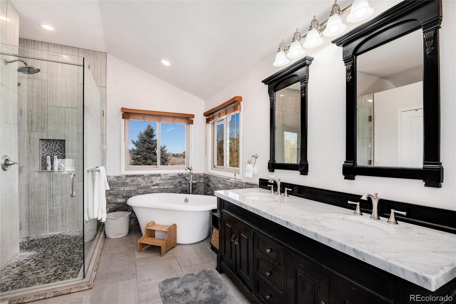 81 North Ranch Road Littleton, CO 80127 - Photo 20 of 38 a bathroom with a double vanity sink a mirror and a bathtub