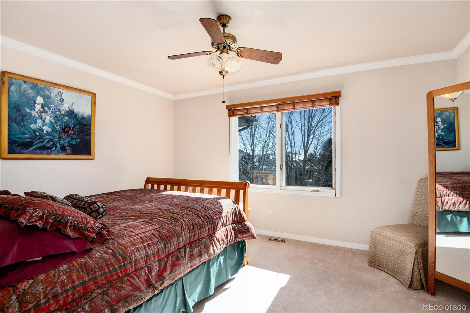 81 North Ranch Road Littleton, CO 80127 - Photo 22 of 38 a bedroom with a bed and a painting on the wall