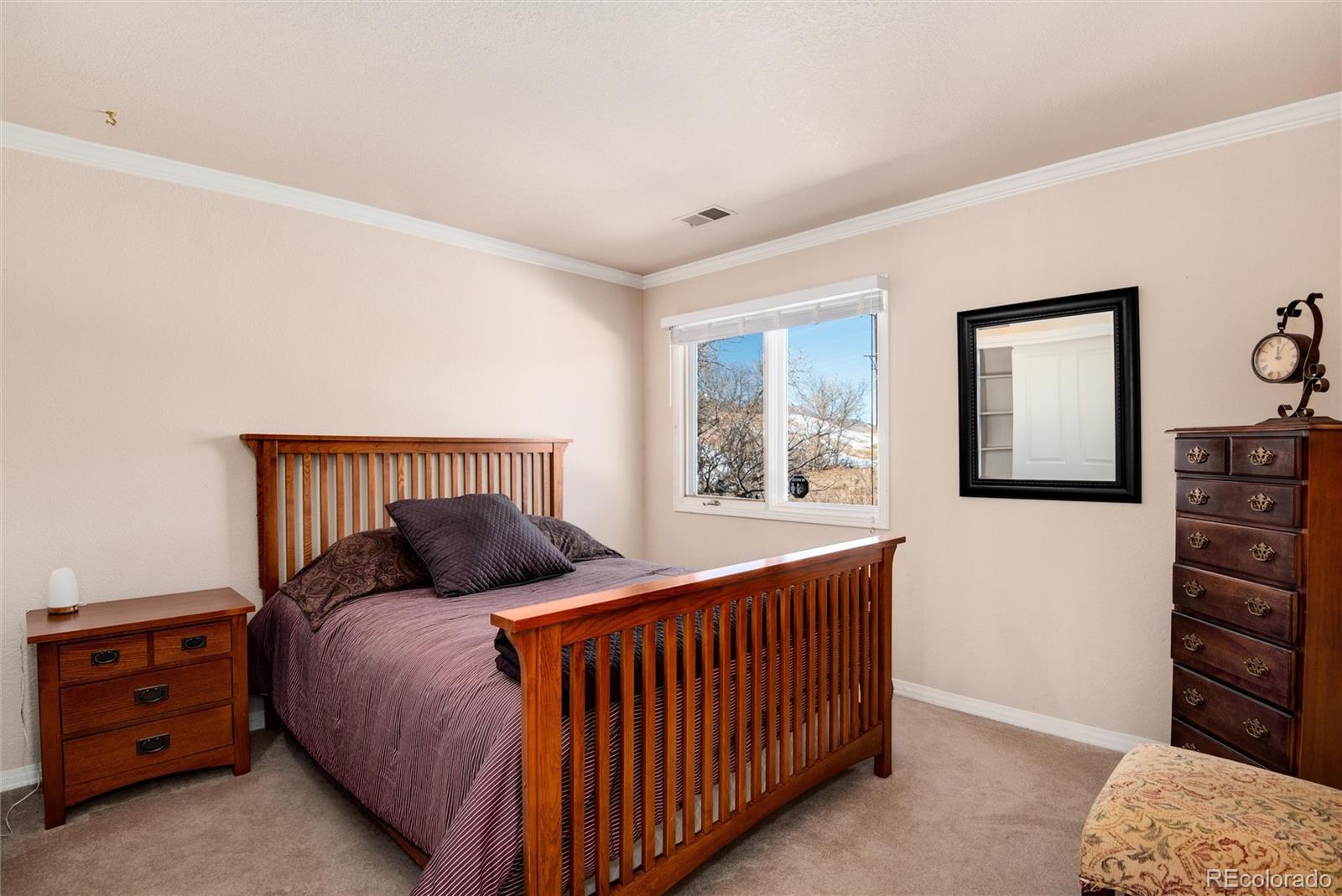 81 North Ranch Road Littleton, CO 80127 - Photo 23 of 38 a bedroom with a bed and a window