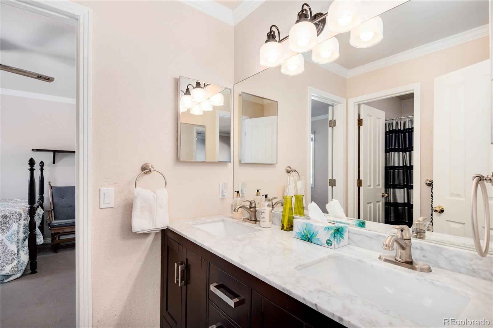 81 North Ranch Road Littleton, CO 80127 - Photo 24 of 38 a bathroom with a sink vanity and a mirror