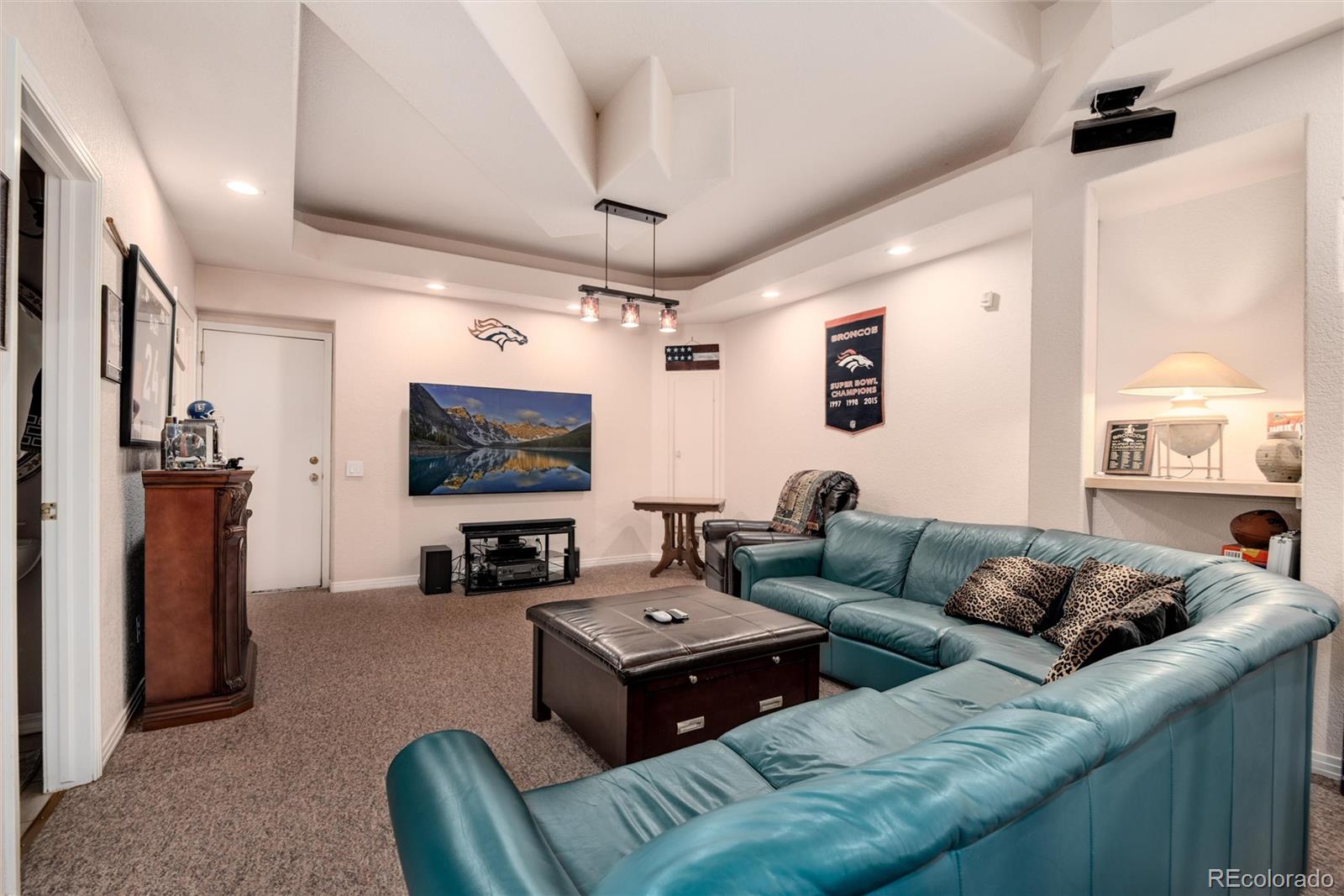 81 North Ranch Road Littleton, CO 80127 - Photo 25 of 38 a living room with furniture and a flat screen tv