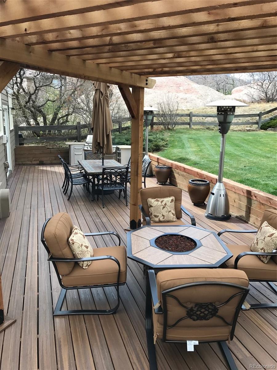 81 North Ranch Road Littleton, CO 80127 - Photo 28 of 38 a view of patio with table and chairs and wooden floor
