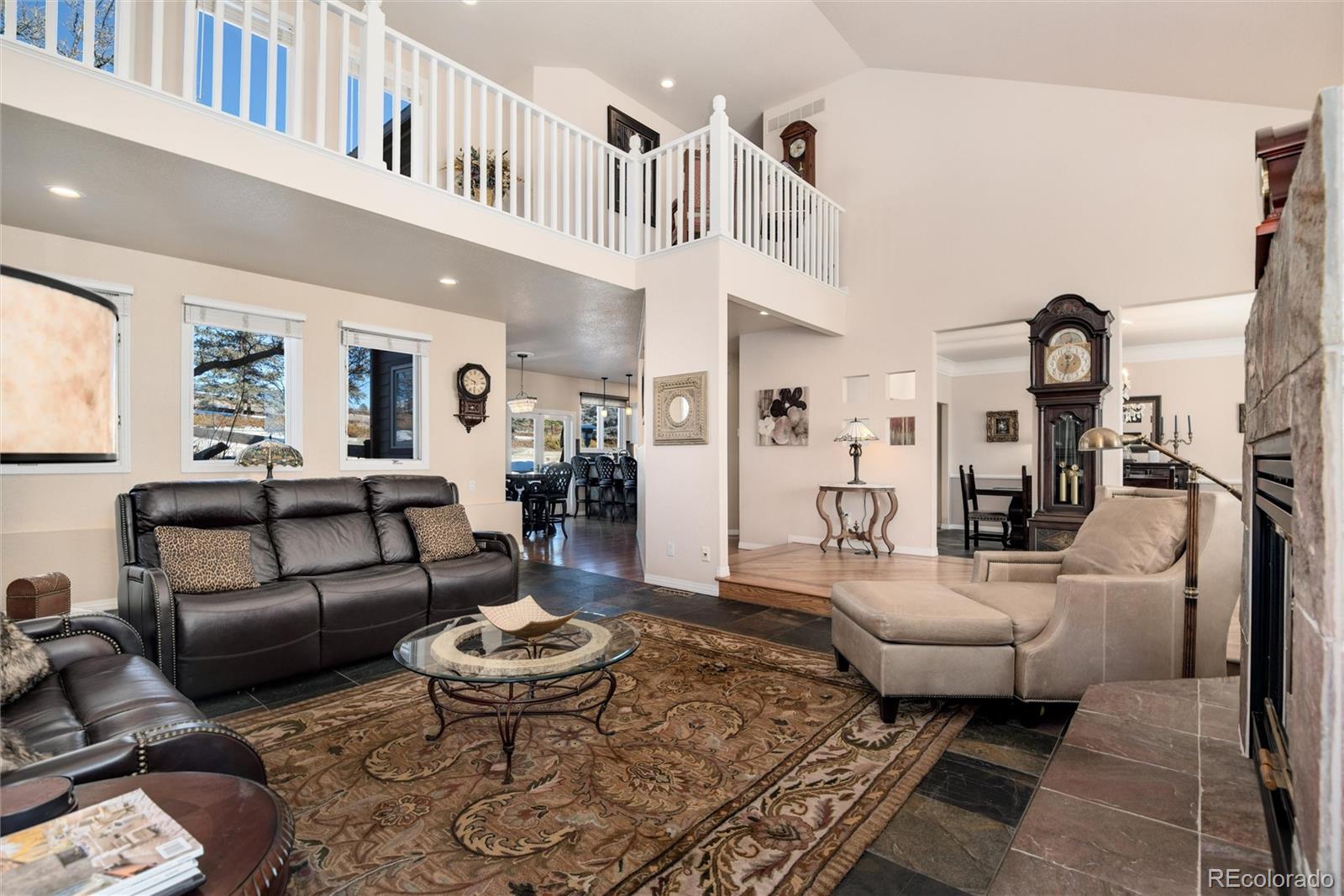 81 North Ranch Road Littleton, CO 80127 - Photo 7 of 38 a living room with furniture a rug and a chandelier