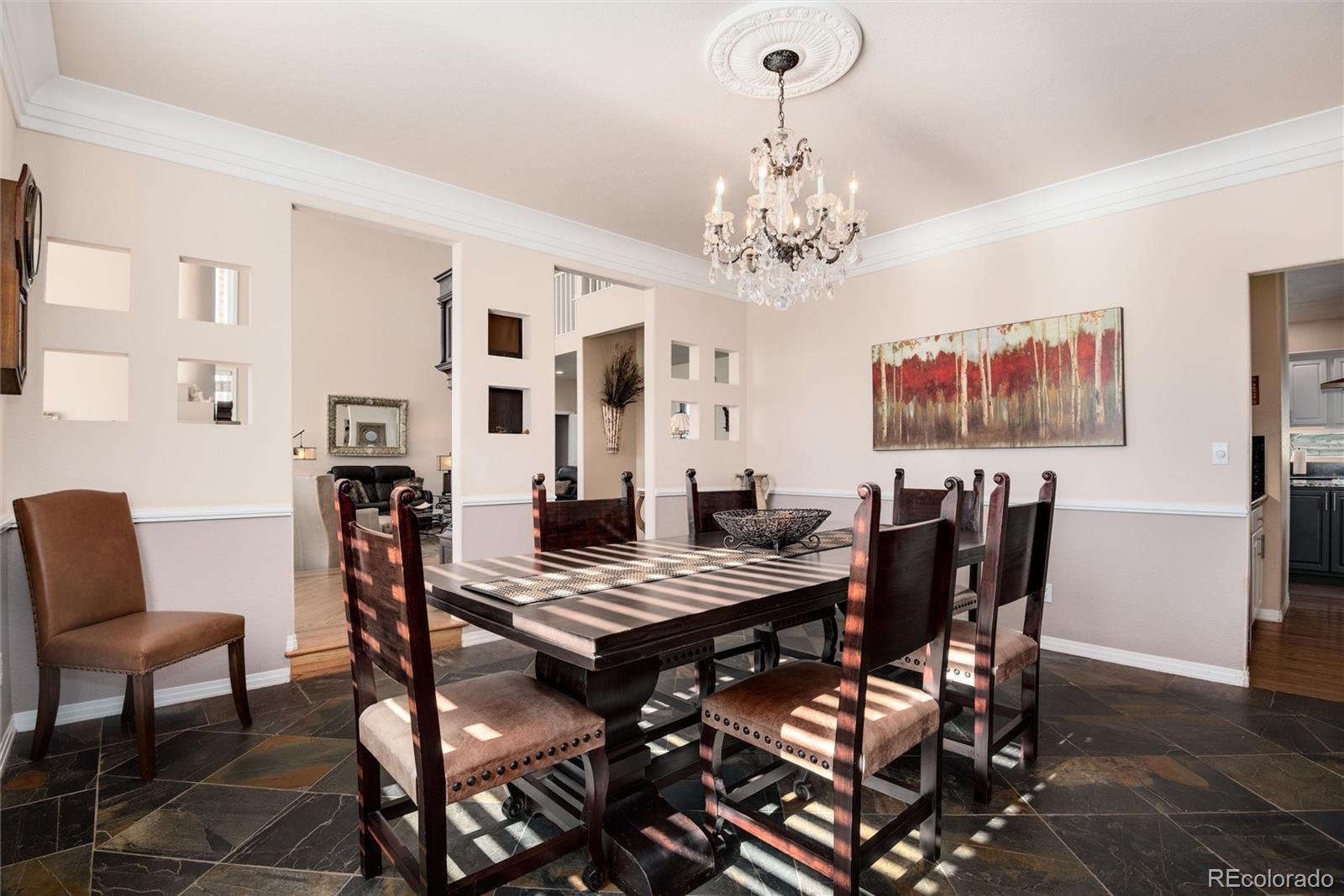 81 North Ranch Road Littleton, CO 80127 - Photo 8 of 38 a view of a dining room with furniture and chandelier