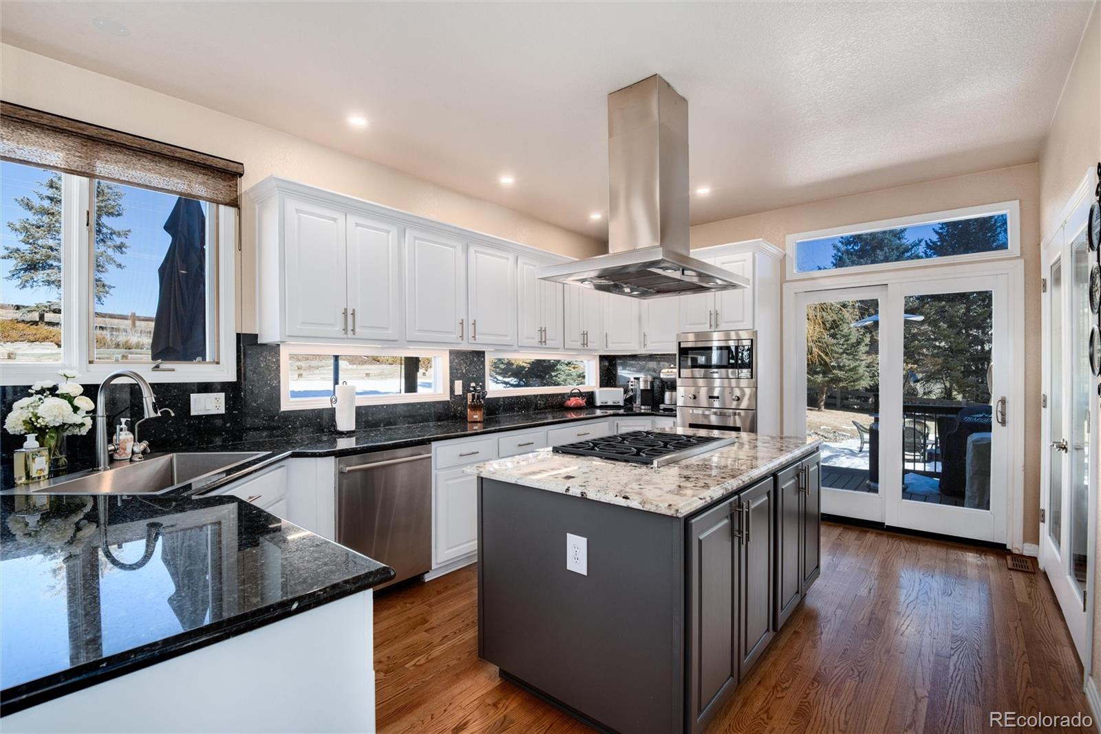 81 North Ranch Road Littleton, CO 80127 - Photo 9 of 38 a kitchen with a stove sink and refrigerator