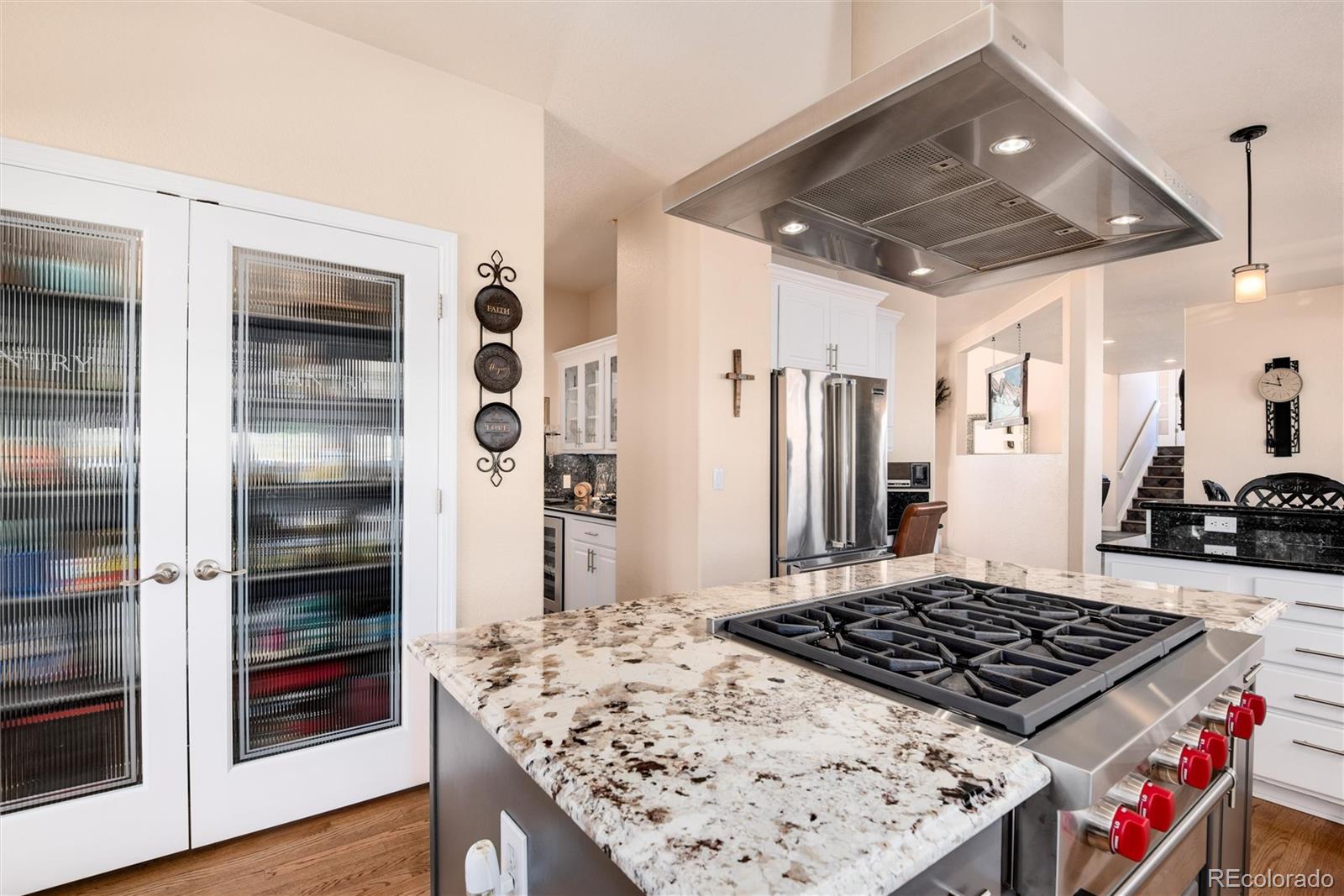 81 North Ranch Road Littleton, CO 80127 - Photo 10 of 38 a kitchen with stainless steel appliances granite countertop a stove and a refrigerator