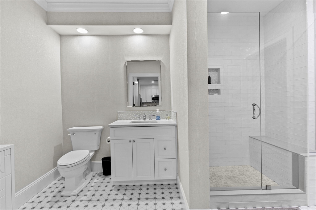 59 Walpole Street, Unit 116 Canton, MA 02021 - Photo 14 of 26 a bathroom with a toilet a sink and a mirror