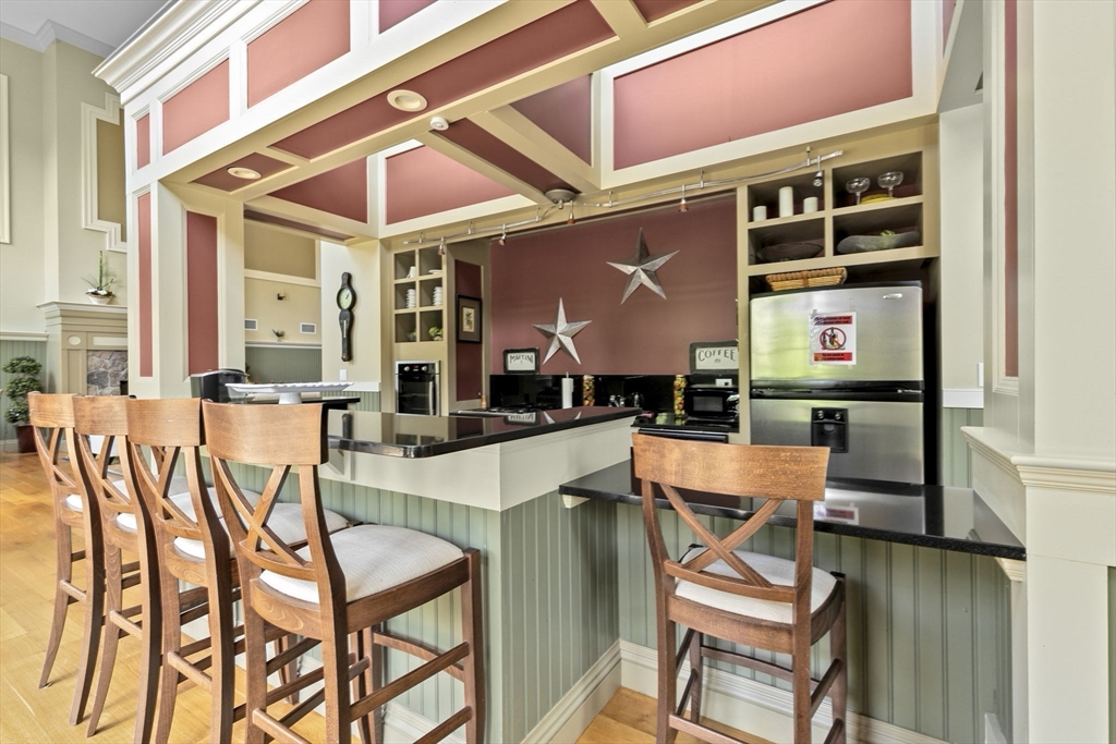 59 Walpole Street, Unit 116 Canton, MA 02021 - Photo 18 of 26 a patio with a table and chairs and potted plants