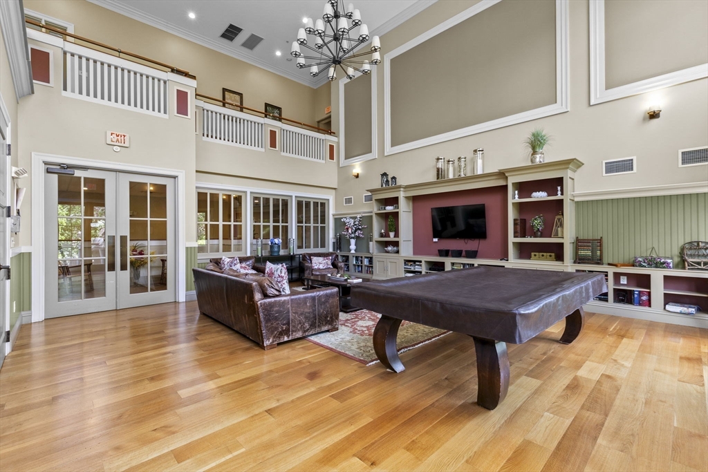 59 Walpole Street, Unit 116 Canton, MA 02021 - Photo 19 of 26 a living room with furniture a table and kitchen view