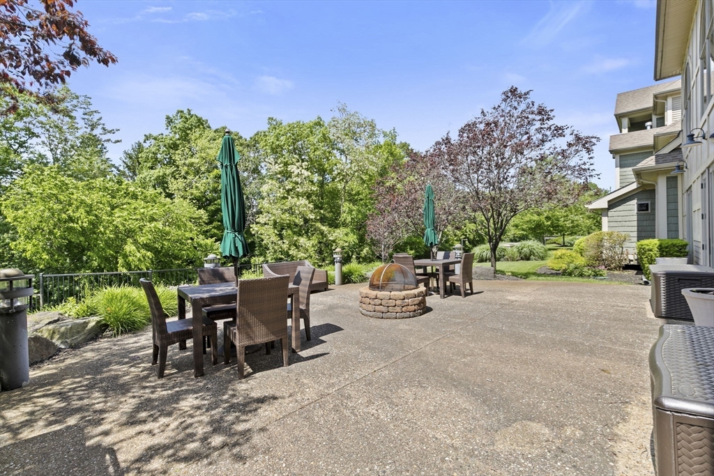 59 Walpole Street, Unit 116 Canton, MA 02021 - Photo 20 of 26 a view of a patio with table and chairs and potted plants