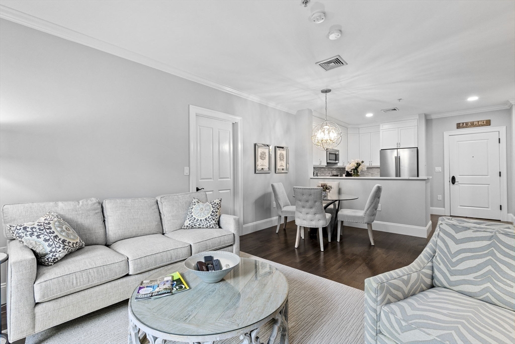 59 Walpole Street, Unit 116 Canton, MA 02021 - Photo 7 of 26 a living room with furniture white walls and white walls
