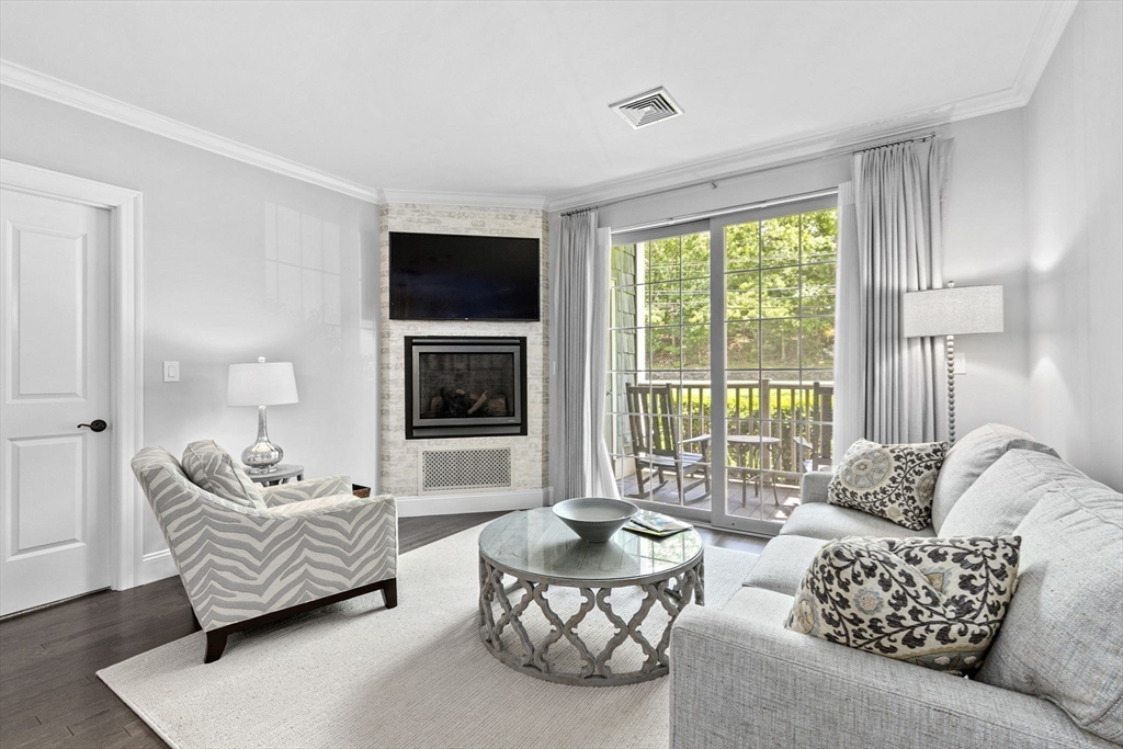 59 Walpole Street, Unit 116 Canton, MA 02021 - Photo 8 of 26 a living room with furniture or couch and a flat screen tv