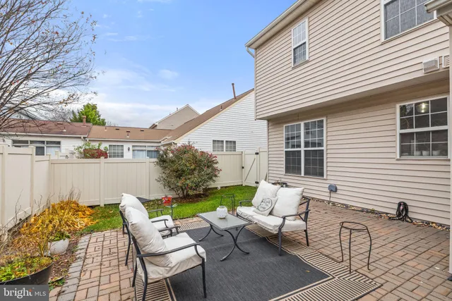 a view of house with a chairs and table in a patio