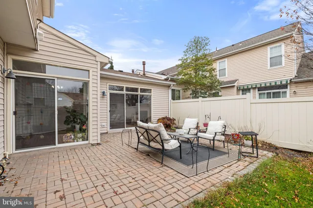 a view of a patio with couches and a fire pit
