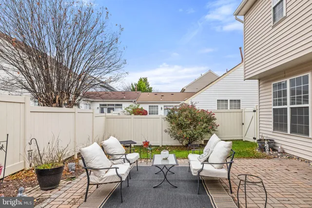 a backyard of a house with outdoor seating